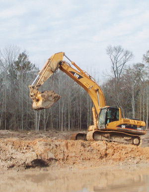 An excavator digging a pond