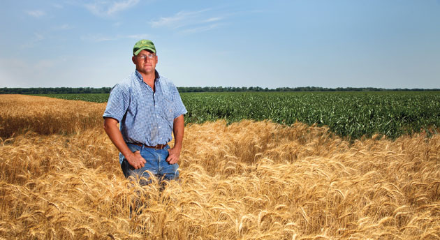 Justin Young standing in a wheat field