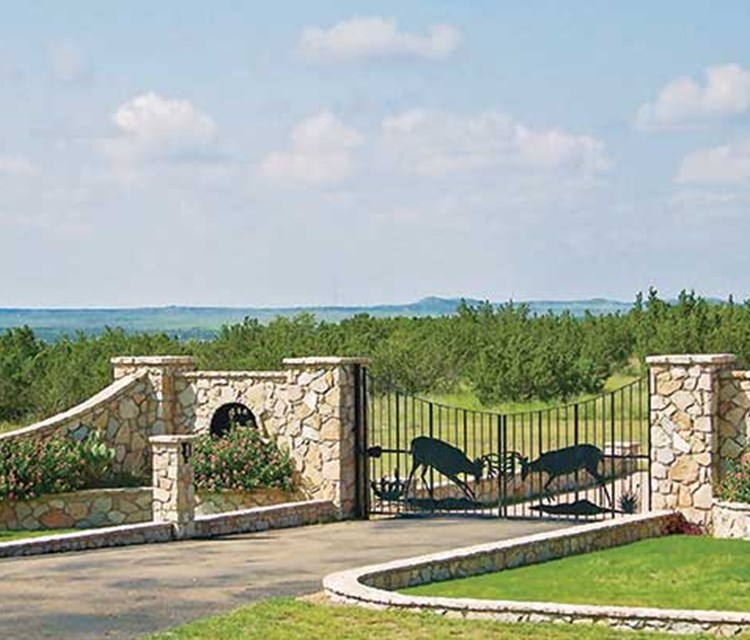 stone walls and wildlife-themed metal work at a northwest texas ranch