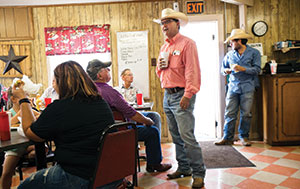 Joe Don Pogue visits with customers in the café.