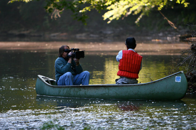 Dr. Phillips and cameraman in a canoe