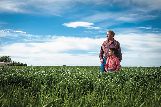 Jeff and Luke Harrell out standing in their field