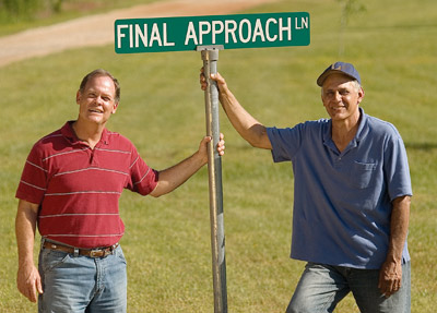 Pilots Steve Specht and Larry Rhea hold a sign for Final Approach Lane