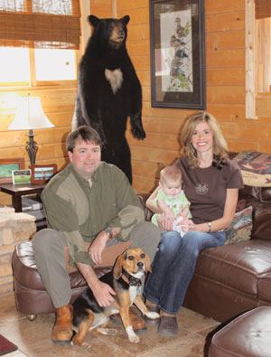 The Creekbaums in their cabin with son, Gray
