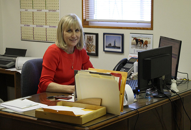Sharon Felderhoff at desk with folders