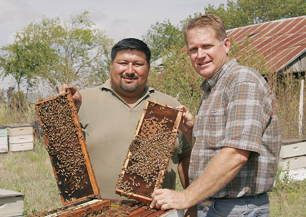 Dr. Clint Walker and Domingo Montalbo with honeycombs