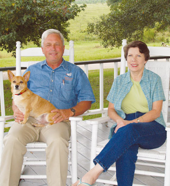 John and Bettye Logan sit on their porch with a cute dog