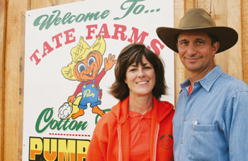Jackie and Steve Tate in front of Tate Farms sign