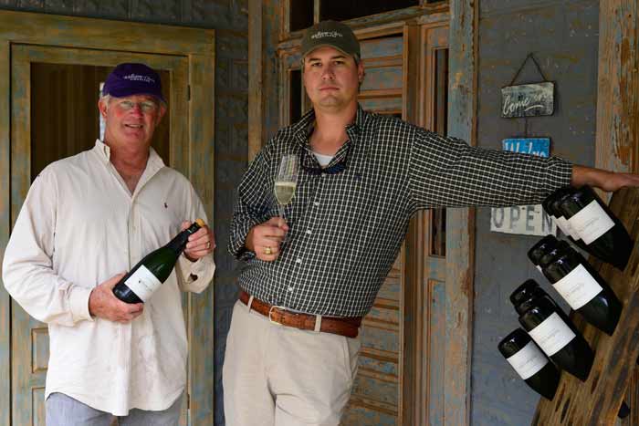 Bill and Chris on porch with wine