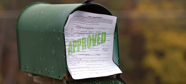 Approved loan application in a green mailbox