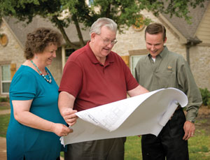 Mary Ann and Marvin Trojacek look at blueprints with Ryan Janek