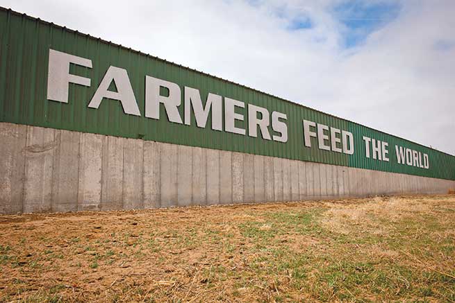 A fence sign proclaims the DeWit family&#x27;s farming pride