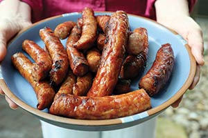 A blue plate with sausage on it