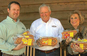 The Sessions family holding sausages