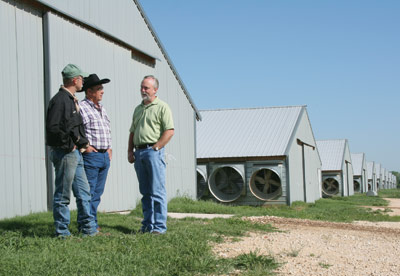 Justin and Paul Young in front of their 12 chicken houses