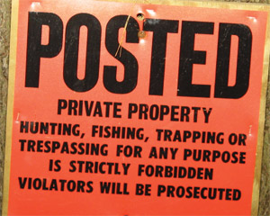 Orange no trespassing sign