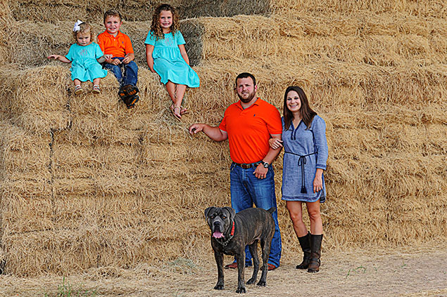 The Morris family on a hill of hay