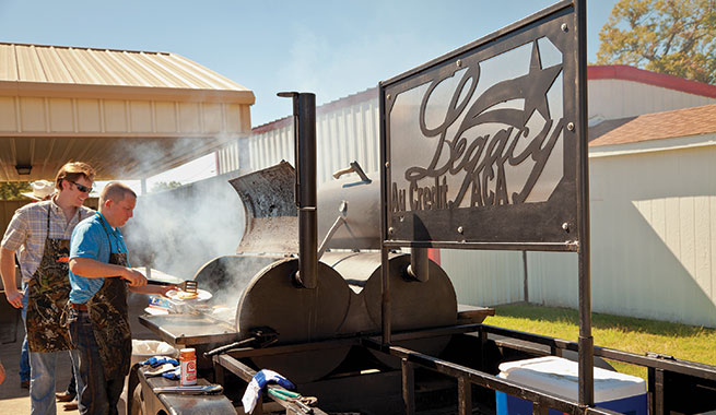 Men cook on smoker