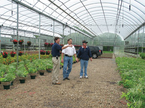 Billy and Bobby Brentlinger inspect some plants in the greenhouse