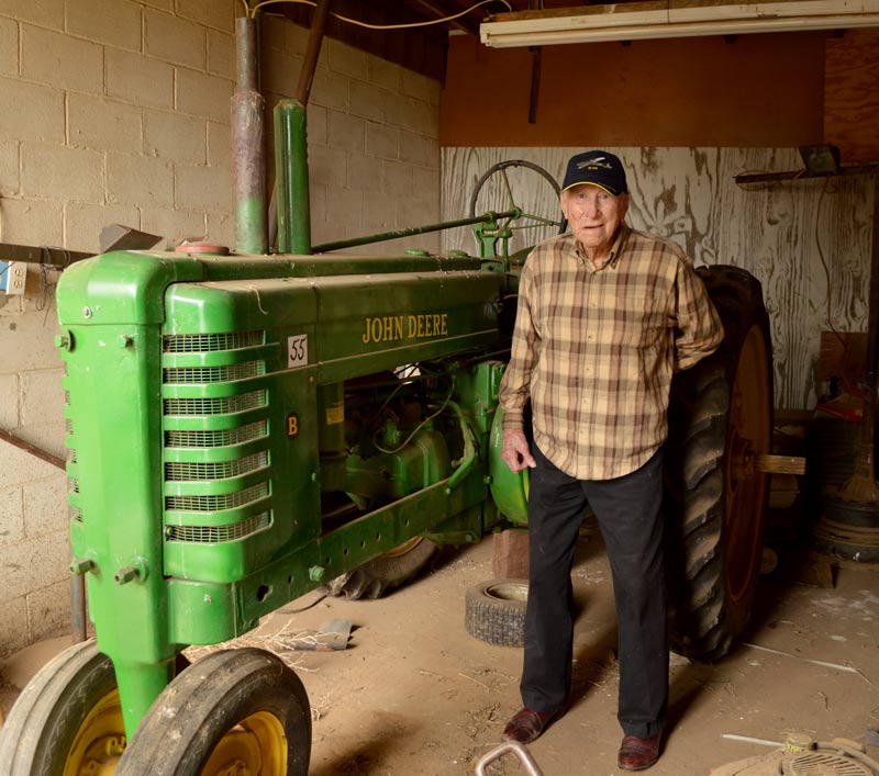 Elmo Snelling with green John Deere tractor