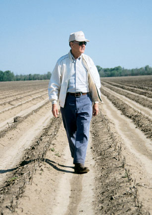 Ray Young walks a plowed field