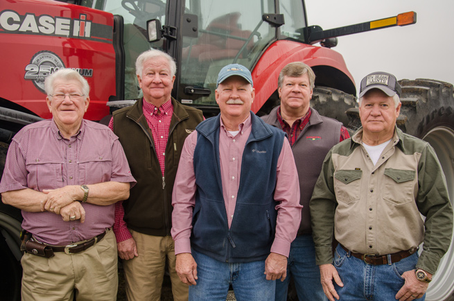 The Marsh brothers in front of a giant red tractor