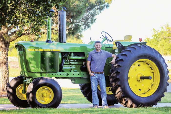 Matt Mahler with his restored 1972 John Deere 4320 diesel