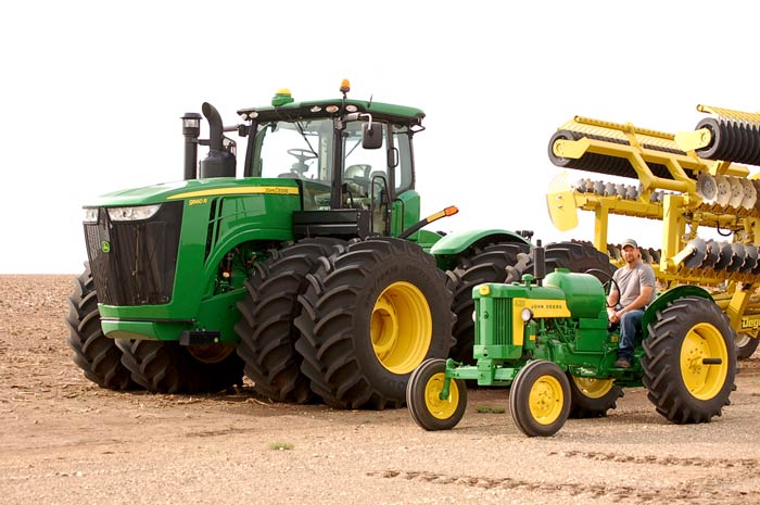 Modern John Deere 8285R and Cody Gruhlkey and his 1959 John Deere 430