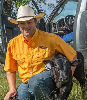 Justin Barrett with a newborn calf