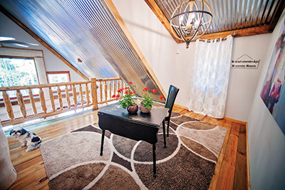 A 400-square-foot loft with 14-foot corrugated metal ceilings overlooks the living area.