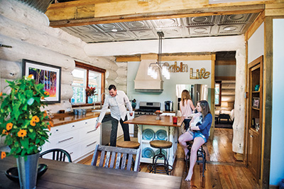 Tongue-and-groove pine flooring extends throughout the house, including the kitchen, where the family often gathers.