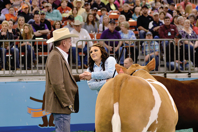 alt="Caitlen Doskocil is congratulated by the judge"