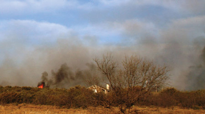 Wildfire threatening house