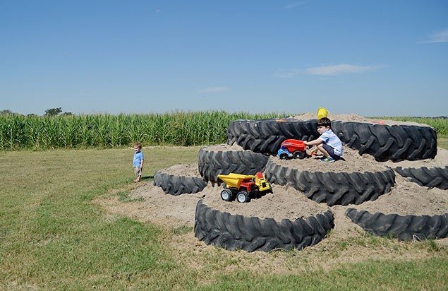 Kids with toy trucks at Rocky Creek Maze