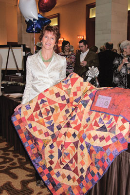 Janet Reinart holding a quilt