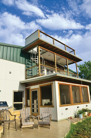 Home attached to barn with spiral staircase and balcony