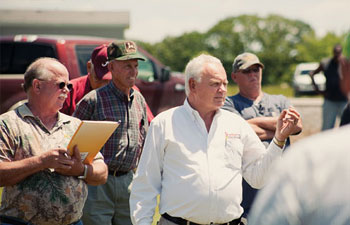 Mickey Fowler in a red shirt leaning against a green chute