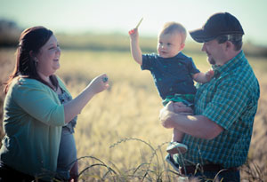 The Shipmans on their farm with their baby