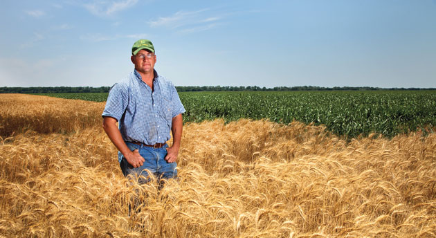 Justin Young standing in a wheat field