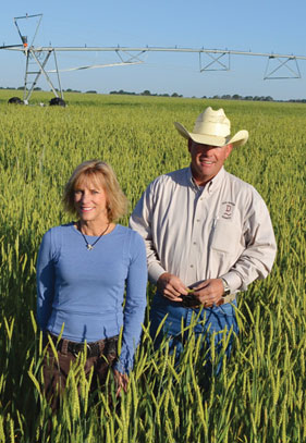 Annie and Mike Dee out standing in their field