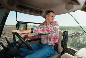 Orlando Cadena in the cab of a tractor