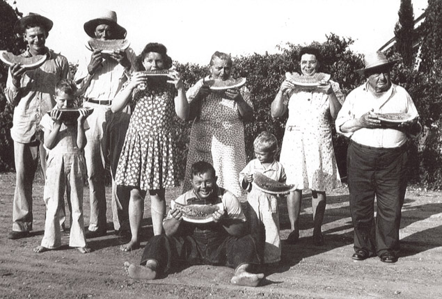 The Fuchs family eating watermelon near Westphalia, Texas - 1940s