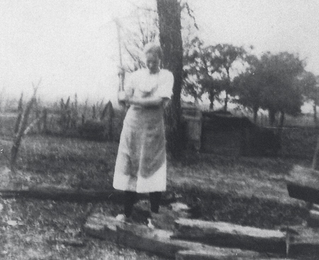 A woman chops wood in Oglesby, Texas - 1926