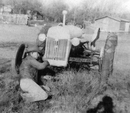 Repairing a Ford tractor on a farm near Aquilla, Texas