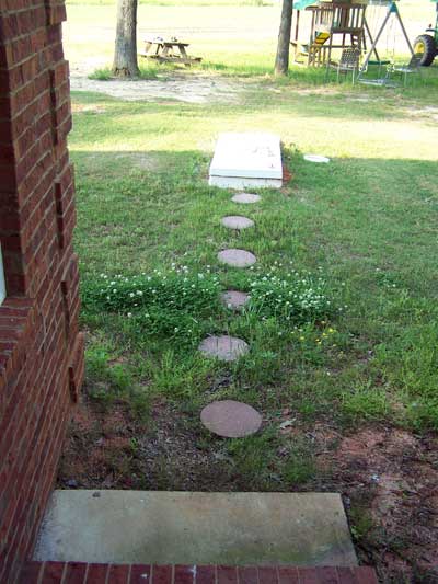 Fiberglass storm shelter located near back door of home