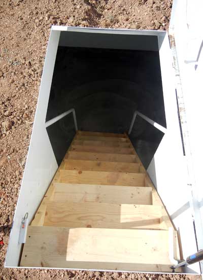 stairs leading down into a prefabricated in-ground storm shelter