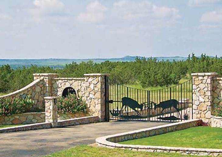 stone walls and wildlife-themed metal work at a northwest texas ranch