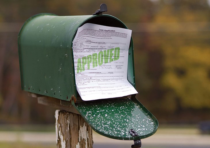 Approved loan application in a green mailbox