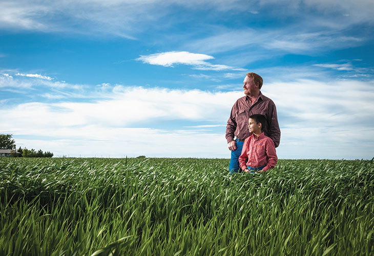 Jeff and Luke Harrell out standing in their field