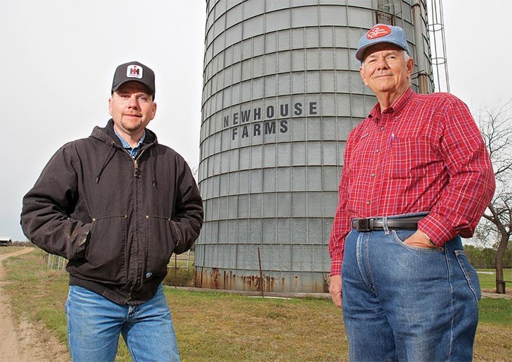 Quentin and Jimmy Newhouse in front of a silo